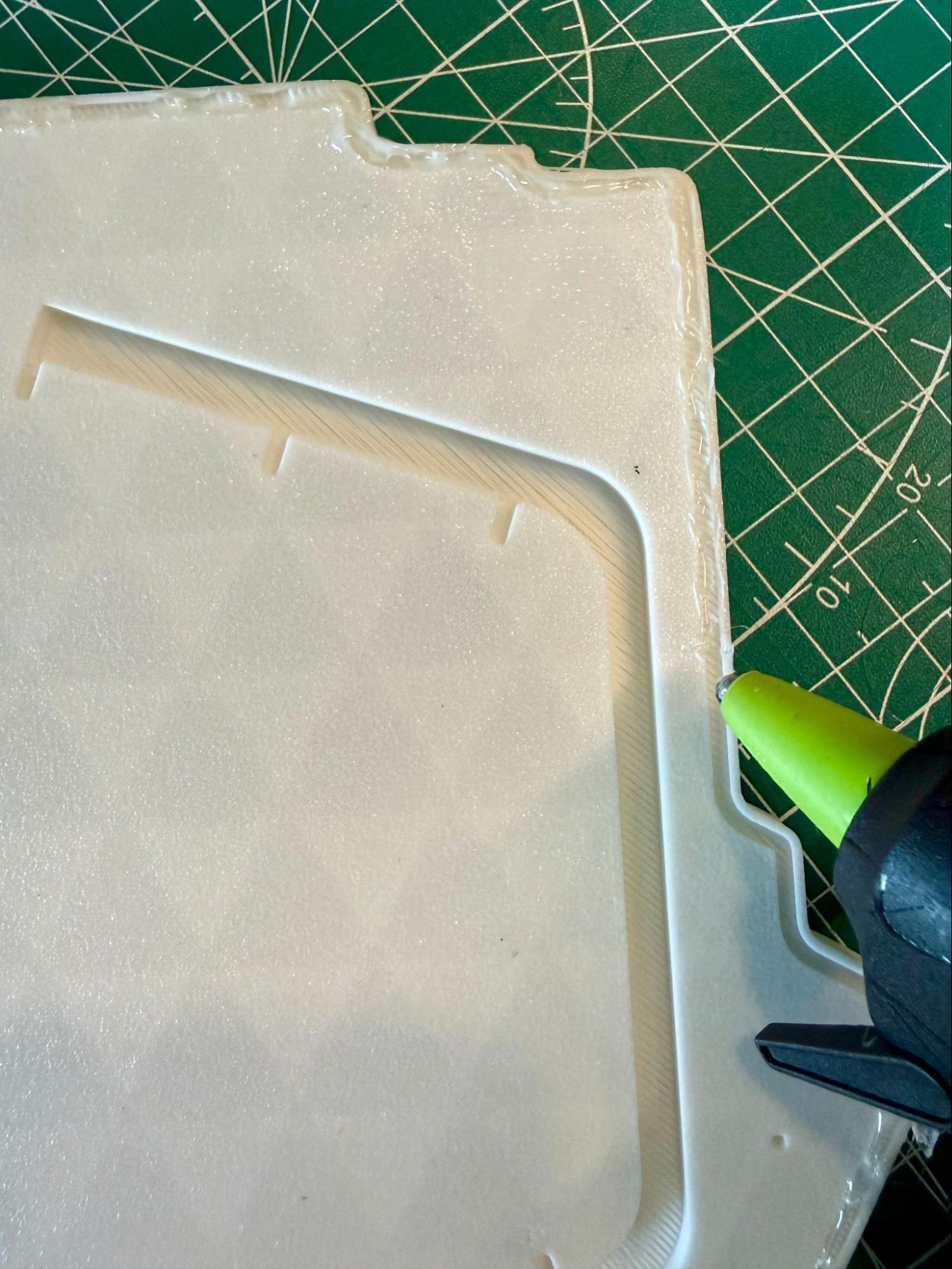 Hot glue gun drawn parallel down the channel