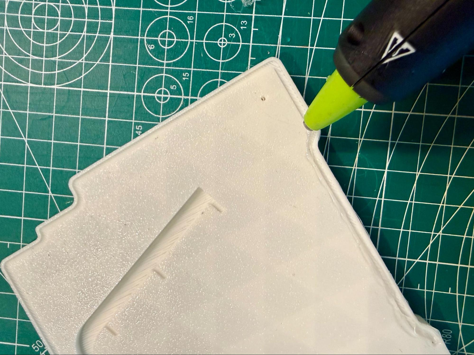 Hot glue gun dragged perpendicular across the channel