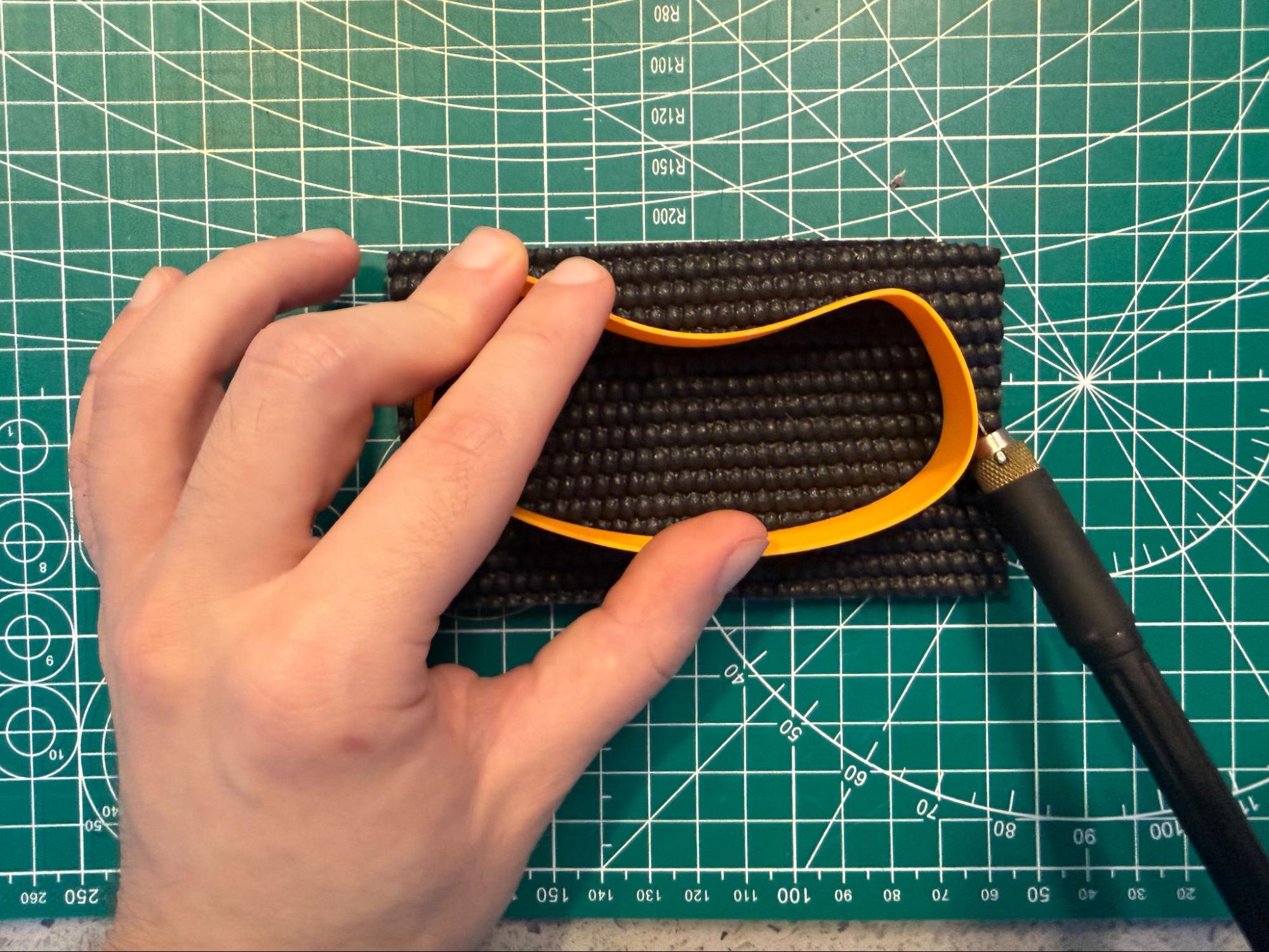 Cutting around the printed guide held down on the padding