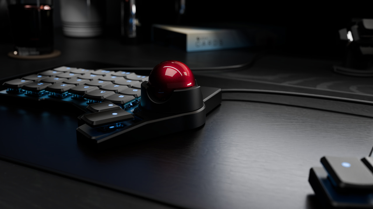 A black trackball attached to the left side of a black voyager keyboard.